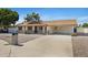 Lovely single-story home with desert landscaping and a spacious driveway leading to a convenient covered carport at 1215 E Geneva Dr, Tempe, AZ 85282