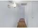 Hallway featuring laminated wood floors, white walls, with doors to bedrooms and bathrooms at 1215 E Geneva Dr, Tempe, AZ 85282