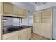 Kitchen with built in cooktop, neutral cabinets, stone floors, and adjacent cabinet at 1215 E Geneva Dr, Tempe, AZ 85282
