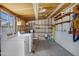 Functional laundry room with washer, dryer, shelving, and ample storage space for household needs at 1215 E Geneva Dr, Tempe, AZ 85282