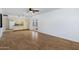 Spacious living area boasts light wood floors, and an open layout connecting the living and kitchen spaces at 1215 E Geneva Dr, Tempe, AZ 85282