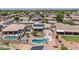 Aerial view of backyard with a private pool, patio, and solar panels on roof at 15019 W Banff Ln, Surprise, AZ 85379