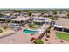 Aerial view of backyard featuring a pool, desert landscaping, and solar panels on the roof at 15019 W Banff Ln, Surprise, AZ 85379