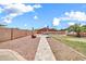 Inviting backyard with a shimmering pool and ample room for outdoor recreation and relaxation at 15019 W Banff Ln, Surprise, AZ 85379