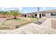 Expansive backyard featuring lush greenery, a covered patio, storage shed, and solar panels at 15019 W Banff Ln, Surprise, AZ 85379