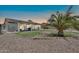 Private backyard with lush landscaping, a well-maintained lawn, and a covered patio perfect for entertaining at 15019 W Banff Ln, Surprise, AZ 85379