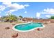 Lovely backyard featuring a custom-shaped pool, desert landscaping, and a relaxing atmosphere at 15019 W Banff Ln, Surprise, AZ 85379