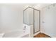 Clean bathroom featuring a shower over tub with sliding doors at 15019 W Banff Ln, Surprise, AZ 85379