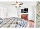 Bright, stylish bedroom featuring a ceiling fan, television, and decorative accents at 15019 W Banff Ln, Surprise, AZ 85379