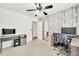 Bedroom with modern desk setup, closet, neutral carpet, and natural light at 15019 W Banff Ln, Surprise, AZ 85379