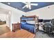 Fun bedroom with a bunk bed, ceiling fan, and a star painted ceiling at 15019 W Banff Ln, Surprise, AZ 85379