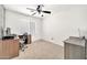 Bright bedroom with a ceiling fan, neutral carpet, and a sunlit window at 15019 W Banff Ln, Surprise, AZ 85379