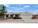 Charming single-story home featuring a well-manicured front yard and attached two-car garage at 15019 W Banff Ln, Surprise, AZ 85379