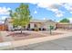 Charming single-story home with well-maintained landscaping and a welcoming front porch at 15019 W Banff Ln, Surprise, AZ 85379