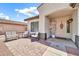 Charming front porch with a seating area, decorative accents, and a welcoming entrance at 15019 W Banff Ln, Surprise, AZ 85379