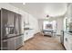 Bright kitchen area featuring stainless appliances, white cabinets, and an adjacent dining area at 15019 W Banff Ln, Surprise, AZ 85379