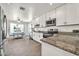 Bright kitchen with white cabinets, granite countertops, stainless steel appliances, and a dining nook at 15019 W Banff Ln, Surprise, AZ 85379