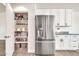 Modern kitchen with stainless steel fridge and pantry with lots of storage at 15019 W Banff Ln, Surprise, AZ 85379