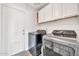 Practical laundry room with modern washer and dryer and tile flooring at 15019 W Banff Ln, Surprise, AZ 85379