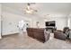 Spacious living room features wood-look tile, and neutral paint with an open concept design at 15019 W Banff Ln, Surprise, AZ 85379