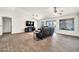 Spacious living room featuring tile flooring and a cozy fireplace at 15019 W Banff Ln, Surprise, AZ 85379