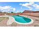 Backyard pool with waterfall feature, rock accents, and a lounge area at 15019 W Banff Ln, Surprise, AZ 85379