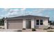 Charming single-story home with a neutral color palette and a well-manicured front yard at 15793 W Beryl Ave, Waddell, AZ 85355