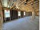 Unfinished home interior featuring wood framing, rough electrical and views to the outside at 15793 W Beryl Ave, Waddell, AZ 85355