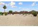 Expansive backyard with rocks, desert landscaping, and a block wall at 16222 W Silver Falls Dr, Surprise, AZ 85374