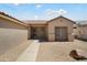 Charming single-story home with desert landscaping, gravel ground cover and a well-manicured front yard at 16222 W Silver Falls Dr, Surprise, AZ 85374