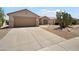 Charming single-story home with a two-car garage, desert landscaping, and well-maintained front yard at 16222 W Silver Falls Dr, Surprise, AZ 85374