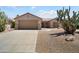 Charming single-story home with a well-manicured desert landscape and a two-car garage at 16222 W Silver Falls Dr, Surprise, AZ 85374