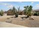 Front yard showcasing desert landscaping with various cacti and gravel ground cover and a two-car garage at 16222 W Silver Falls Dr, Surprise, AZ 85374