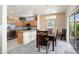 Open-concept kitchen with stainless steel appliances and dining area with natural light at 16222 W Silver Falls Dr, Surprise, AZ 85374