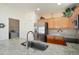 Bright kitchen featuring granite countertops, stainless steel appliances, and a laundry room at 16222 W Silver Falls Dr, Surprise, AZ 85374