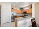 Well-lit kitchen featuring granite countertops, stainless steel appliances, and light wood cabinetry at 16222 W Silver Falls Dr, Surprise, AZ 85374