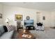Spacious living room offering comfortable seating, neutral paint, plush carpet and great natural light at 16222 W Silver Falls Dr, Surprise, AZ 85374