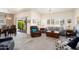 Comfortable living room with plush seating, neutral tones, and natural light filtering through plantation shutters at 16222 W Silver Falls Dr, Surprise, AZ 85374