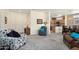 Open concept living room with neutral colors, carpet, and kitchen access; perfect for entertaining at 16222 W Silver Falls Dr, Surprise, AZ 85374
