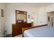 Main bedroom with carpet, a dark wood dresser, and ensuite bath at 16222 W Silver Falls Dr, Surprise, AZ 85374