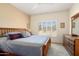 Cozy main bedroom with soft carpet, plantation shutters, and ensuite bath at 16222 W Silver Falls Dr, Surprise, AZ 85374