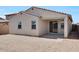A spacious backyard shows the covered patio and stucco exterior of the house at 16784 W Hope Dr, Surprise, AZ 85388
