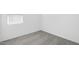 Minimalist bedroom featuring neutral walls, plush carpet, and a bright window, offering a versatile and adaptable space at 16784 W Hope Dr, Surprise, AZ 85388