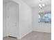 Bright entryway features neutral paint, tiled floors, a modern chandelier, and a white front door at 16784 W Hope Dr, Surprise, AZ 85388
