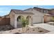Charming single-story home showcasing a tiled roof and arched front porch at 16784 W Hope Dr, Surprise, AZ 85388