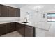 Bright kitchen with counter seating, modern cabinets, stainless appliances, and backyard access at 16784 W Hope Dr, Surprise, AZ 85388
