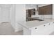 Beautiful kitchen featuring an island with breakfast bar, white countertops, and modern appliances at 16784 W Hope Dr, Surprise, AZ 85388