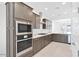 Sleek kitchen featuring stainless appliances, a gas range, and dark cabinetry at 16784 W Hope Dr, Surprise, AZ 85388