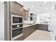 Stylish kitchen with stainless appliances, gas cooktop, abundant cabinetry, and bright lighting at 16784 W Hope Dr, Surprise, AZ 85388