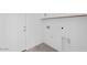 Bright laundry room with washer-dryer hookups and convenient upper cabinets at 16784 W Hope Dr, Surprise, AZ 85388
